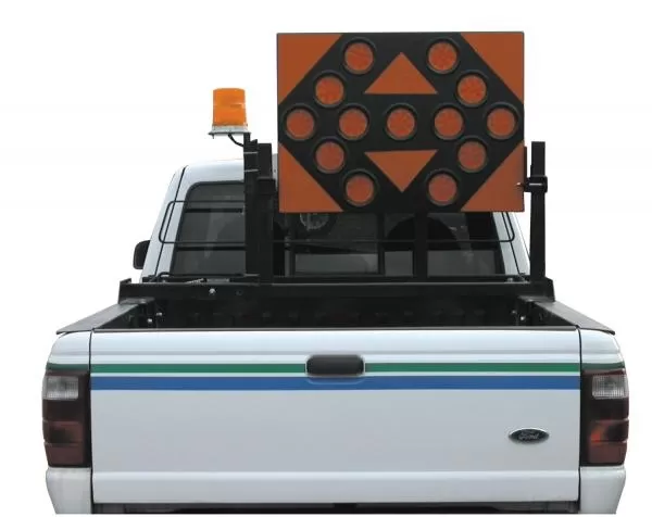 D&R AB253513 TC-12 arrowboard on a bed rack of a white pickup with an amber beacon beside it