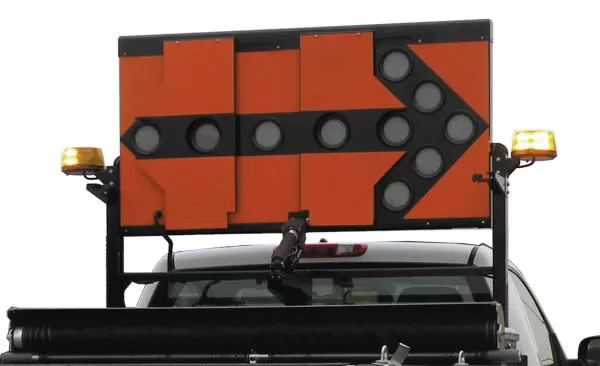 Unlit board showing the black lamp bezels forming a right-pointing arrow on the orange reflective face