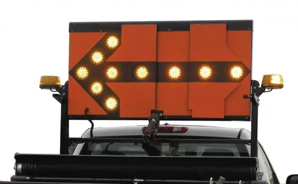 Close-up of the orange reflective panel with the left arrow lit in amber and a beacon on each rack corner