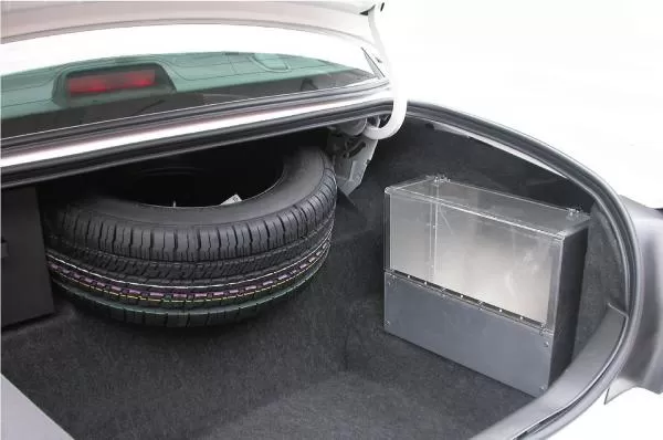 D&R SB04 aluminum storage box with plexi-glass latching cover mounted in a car trunk beside the spare tire