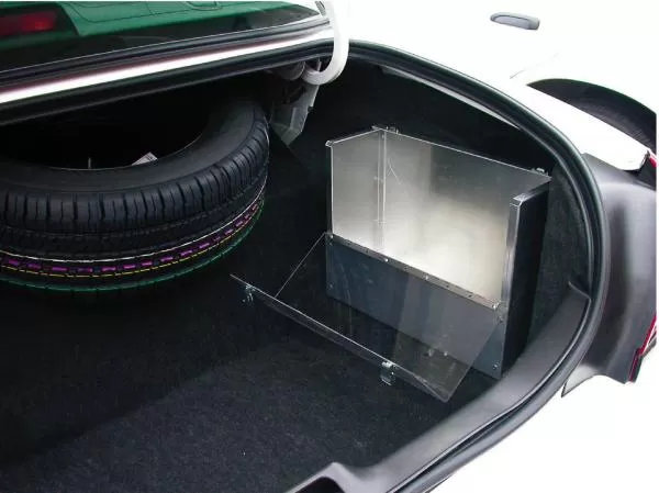 Angled view of the trunk-mounted box showing the clear latching cover and its floor mounting brace