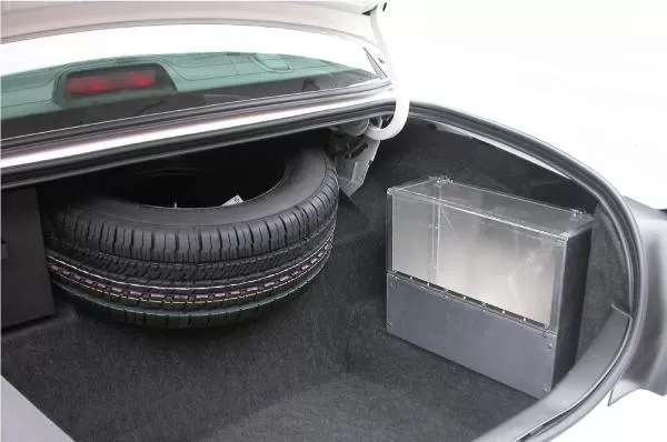 D&R SB04 aluminum storage box with plexi-glass latching cover mounted in a car trunk beside the spare tire