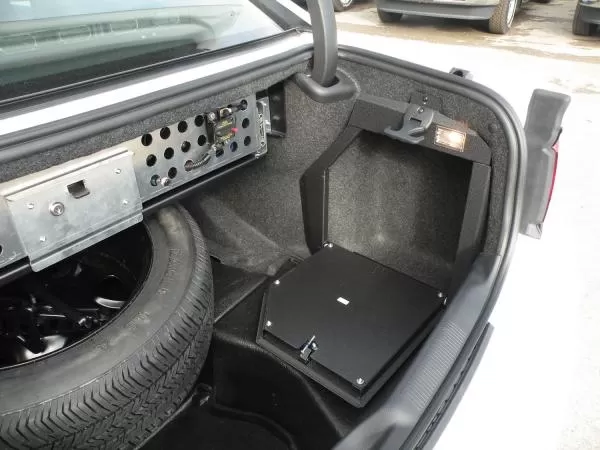 D&R 932-0014A trunk electronic mount door in a Dodge Charger beside the spare tire and equipment panel