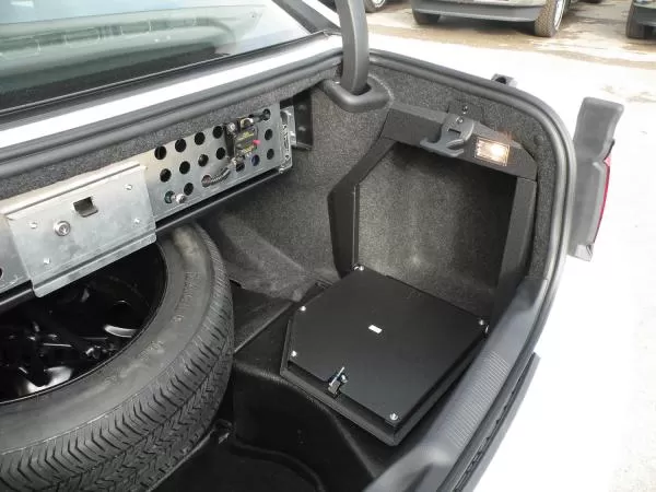 D&R 932-0014A trunk electronic mount door in a Dodge Charger beside the spare tire and equipment panel