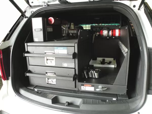 Angled shot of the closed drawer stack beside the equipment tray with flashlight chargers