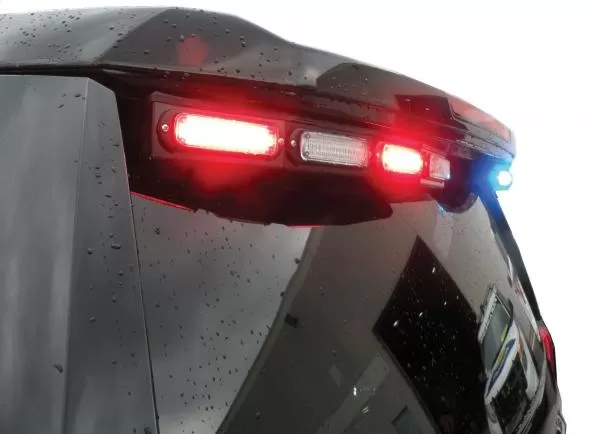 D&R GT2FTL-IC-TAH15 rear spoiler LED light stick flashing red on a rain-beaded Chevy Tahoe tailgate
