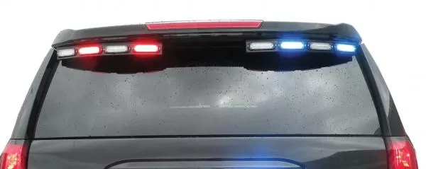 Full-width rear view of a Tahoe with red, white and blue modules lit across the top of the back window