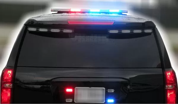 Rear of a black SUV with the roof bar and rear window LED strips flashing red and blue