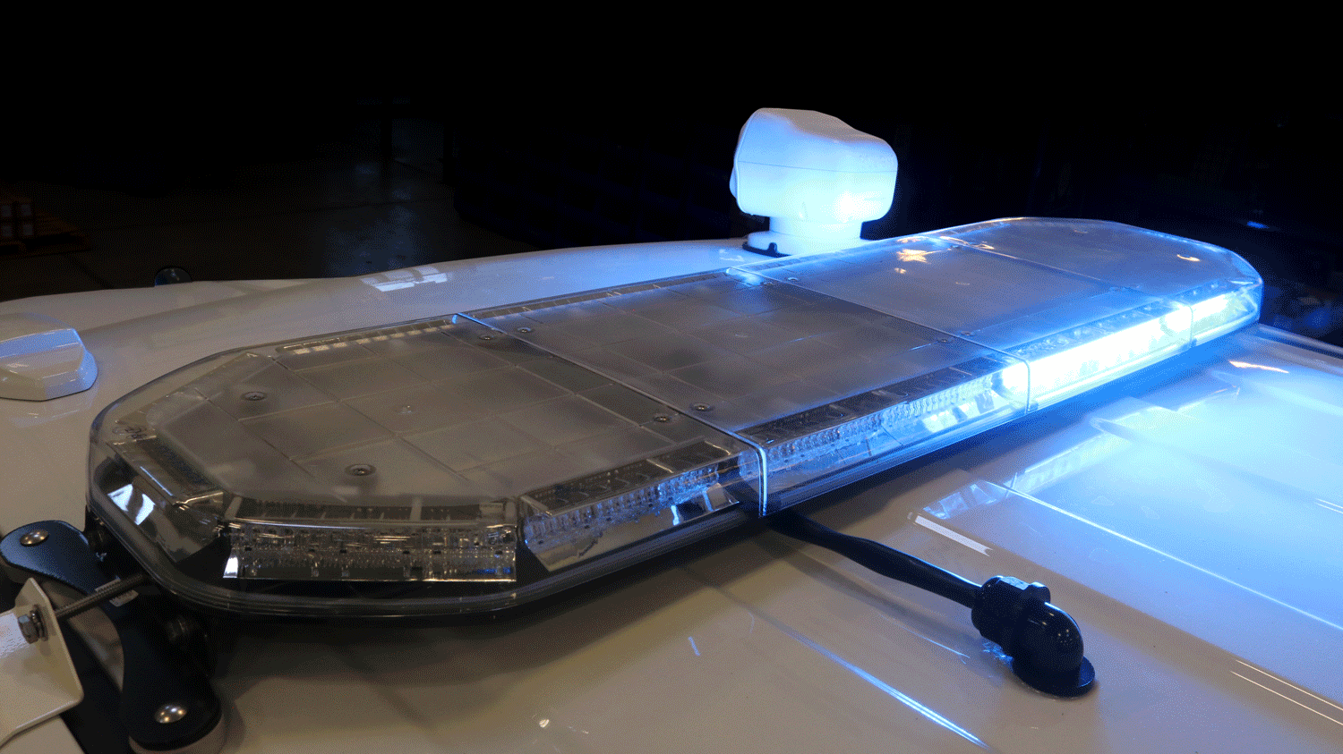 D&R Synergy LED lightbar on a cruiser roof at night, red and blue modules lit behind a clear lens