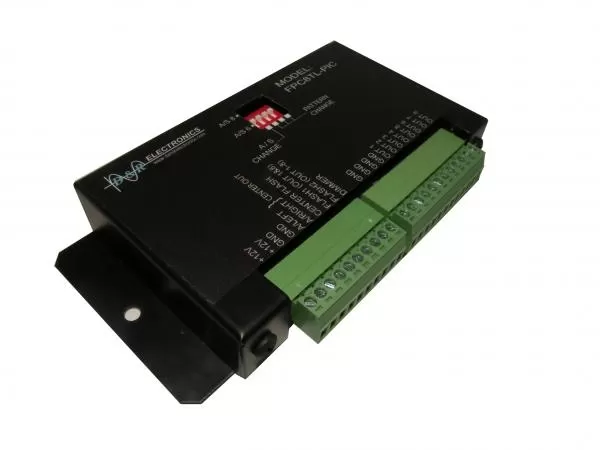 D&R FPC8TL-PIC tail light flasher module at an angle, showing the DIP switches and mounting flange