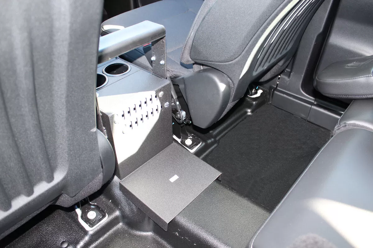Rear floor tray and back bracket of the console where it bolts to the vehicle floor behind the seats