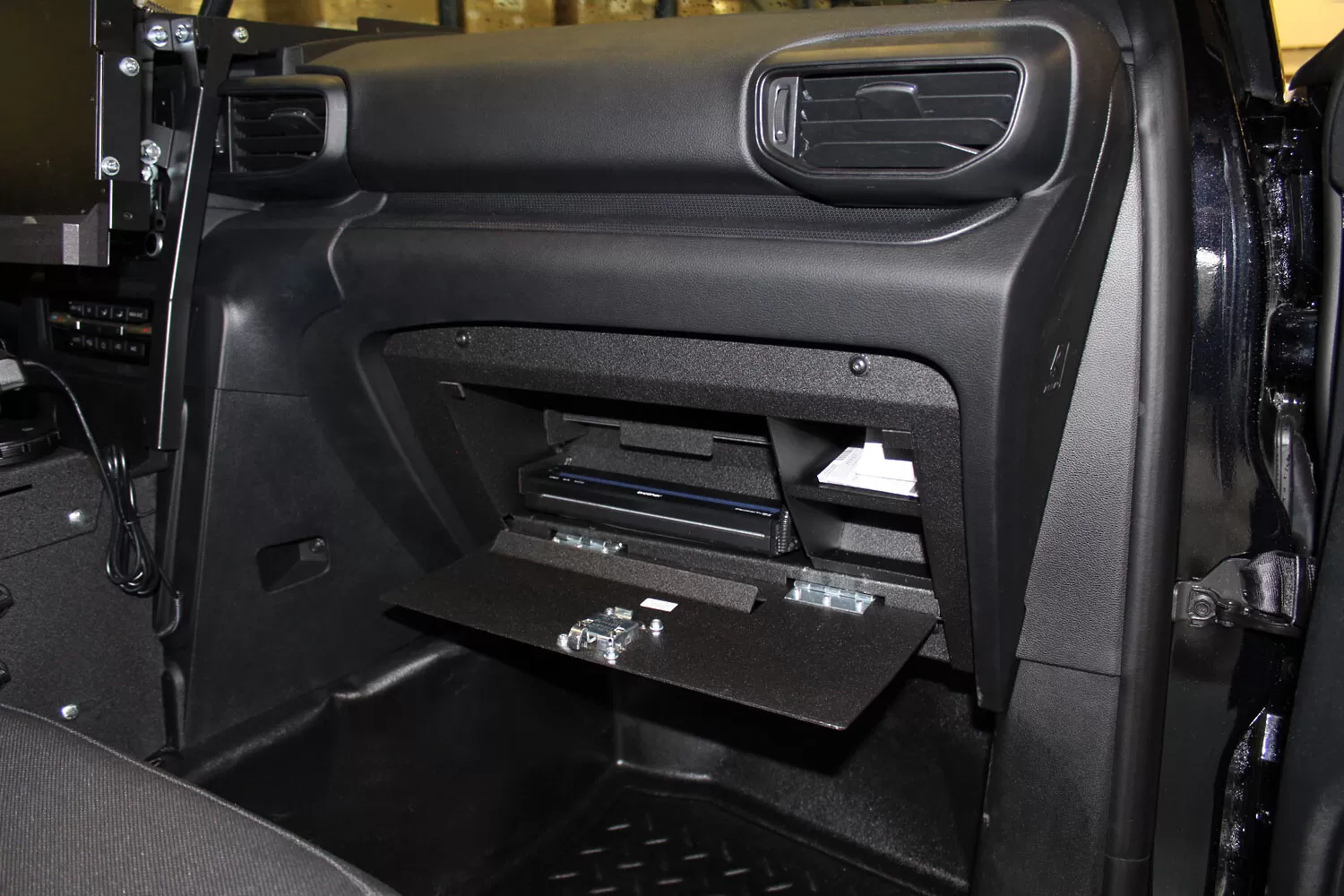 Wide dash view with the drop-down door open, showing the printer bay and side storage compartments