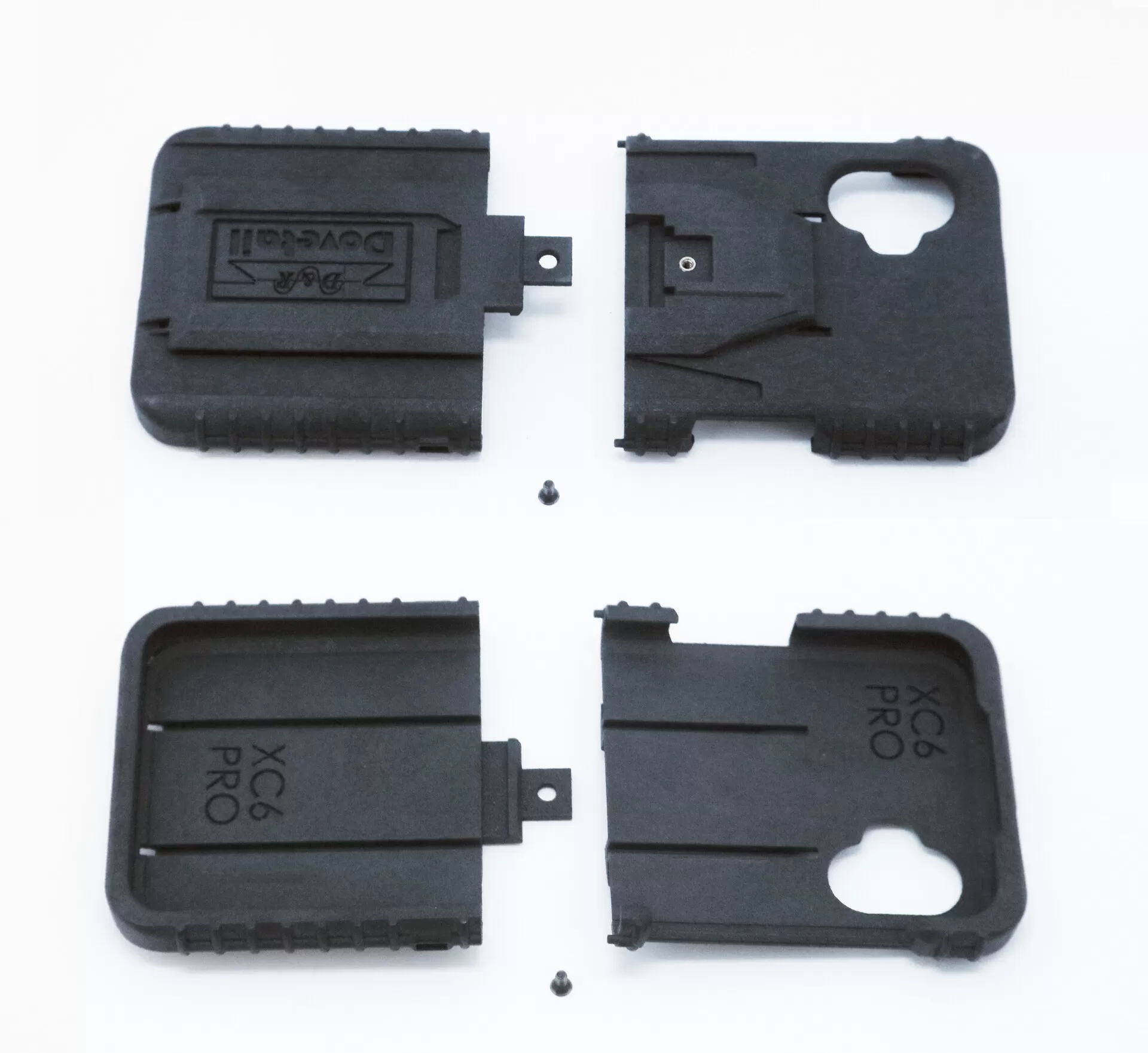 All four molded parts and two mounting screws laid out flat, dock face above, phone cavity below