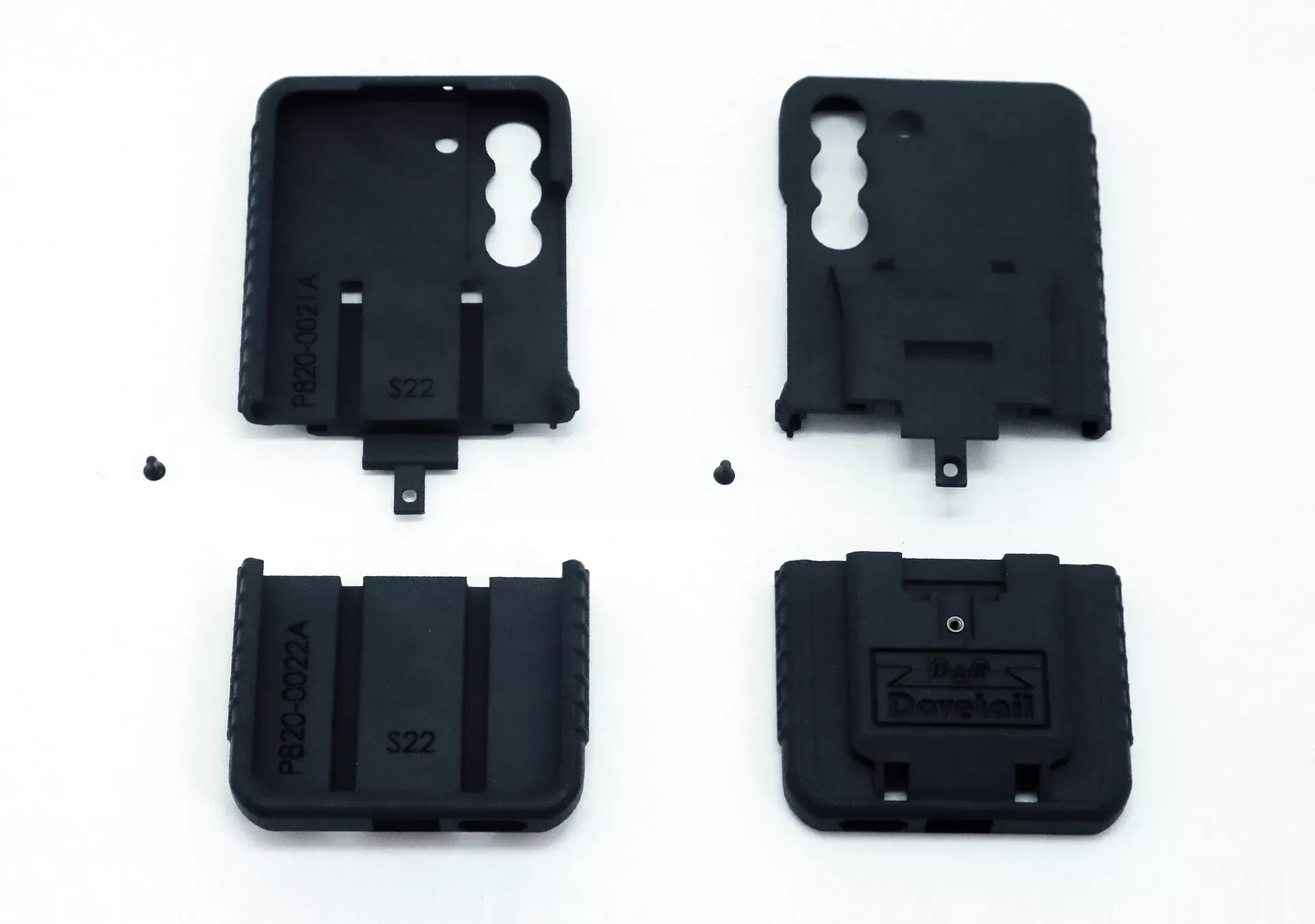 All four moulded parts and the two assembly screws laid out on white before assembly