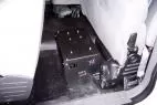 Unit bolted to the rear floor of a cruiser with a fuse strip and wiring connectors on the end panel