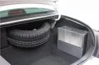 D&R SB04 aluminum storage box with plexi-glass latching cover mounted in a car trunk beside the spare tire