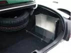 Angled view of the trunk-mounted box showing the clear latching cover and its floor mounting brace