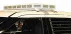 Board retracted flush into the low-profile roof unit on a white SUV, all LED modules unlit