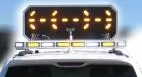 D&R Mini Odyssey arrowboard raised above a white lightbar, amber LEDs lit in a split arrow pattern