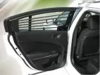 Rear door open on a Charger, showing the horizontal bar set fitted inside the door glass