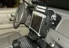 Control head mounted on the dash above a laptop and keyboard in an outfitted police cruiser