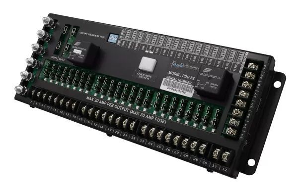 Angled from the left showing terminals numbered 7 to 32 marked max 20 amp per output with fuse rows