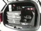 Angled shot of the closed drawer stack beside the equipment tray with flashlight chargers