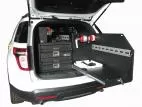 Slide-out tray extended past the rear bumper, slotted mounting panel and extinguisher alongside