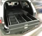 Drawer pulled fully open showing adjustable dividers splitting the tray into separate compartments
