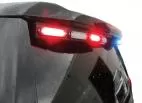 D&R GT2FTL-IC-TAH15 rear spoiler LED light stick flashing red on a rain-beaded Chevy Tahoe tailgate