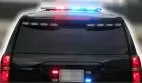 Rear of a black SUV with the roof bar and rear window LED strips flashing red and blue