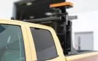 D&R MiniTech mini LED light bar with amber lens raised on an elevating pole above a utility truck box