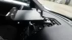 Close-up of the dash mount plate bolted to the passenger side of the dash with the dock body at left