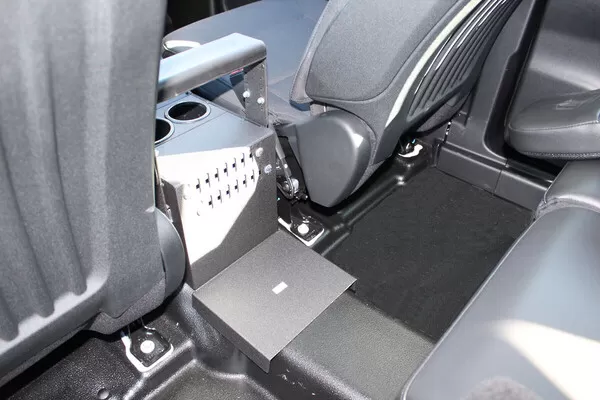 Rear floor tray and back bracket of the console where it bolts to the vehicle floor behind the seats