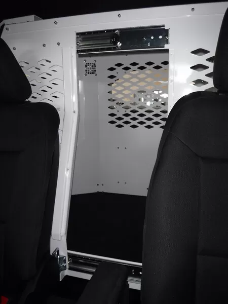 Front barrier seen from the front seats, diamond-mesh window and overhead slide track for the dog door