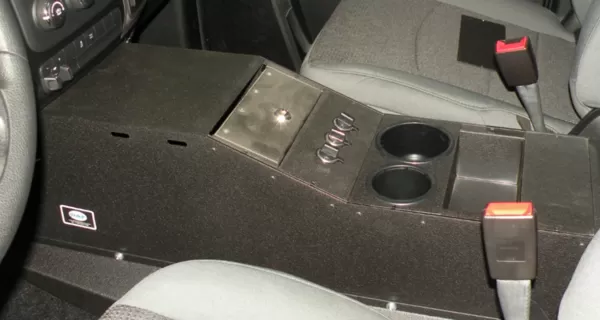 D&R 901-0124A console for the Dodge Ram installed between the seats with hinged lid and dual cup holders