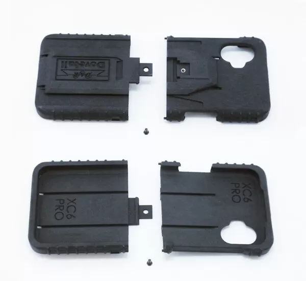 All four molded parts and two mounting screws laid out flat, dock face above, phone cavity below