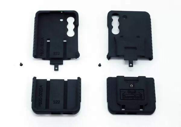 All four moulded parts and the two assembly screws laid out on white before assembly